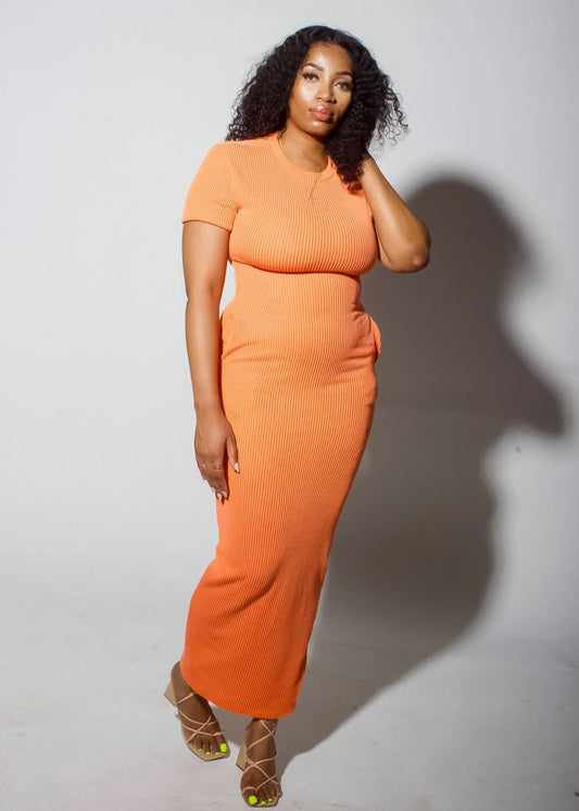 Model posing in an Orange Cozy Bodycon Dress, featuring a sleek, figure-hugging fit and vibrant orange color.