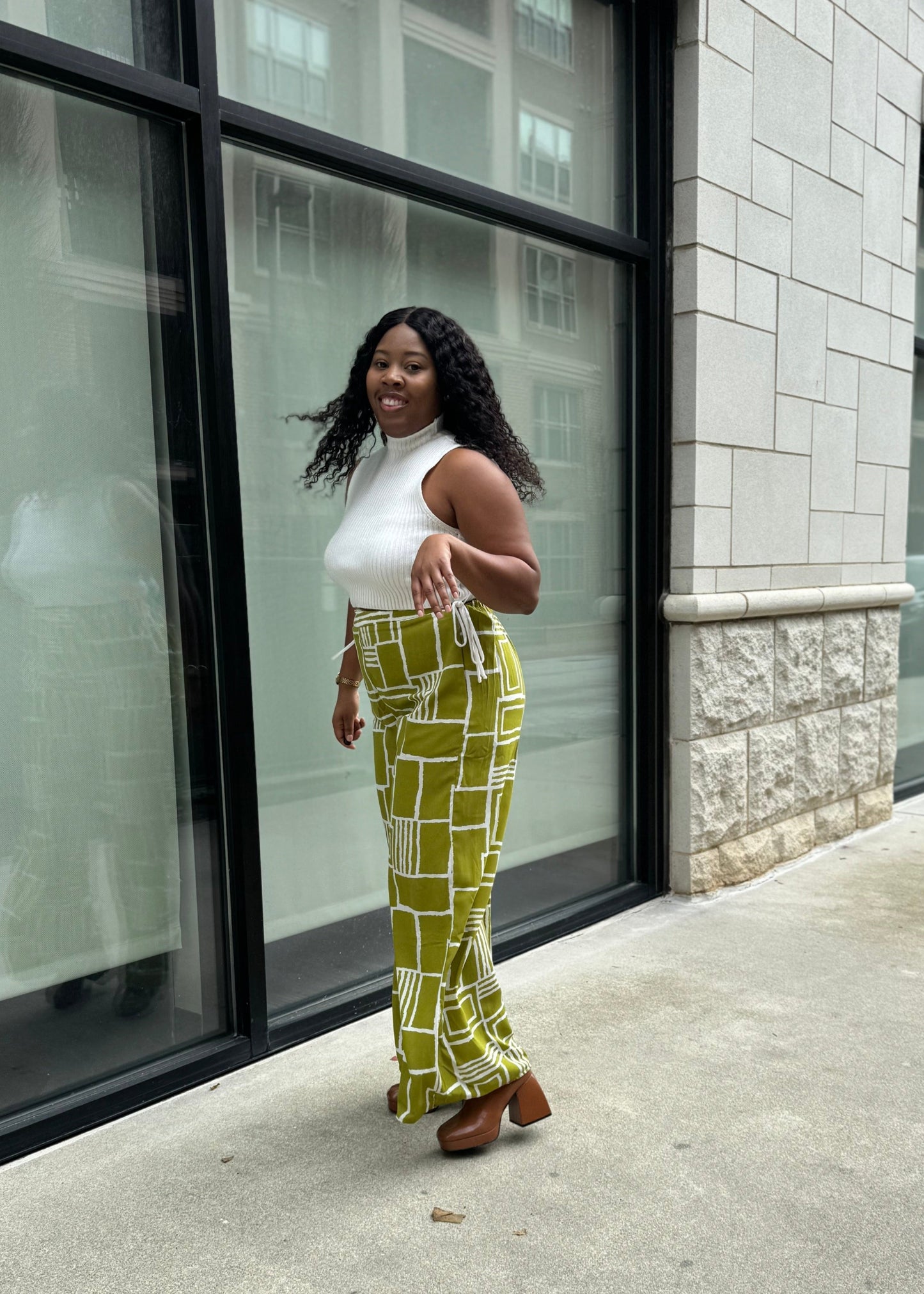 Bright green wide-legged pants with a slim waist and side pockets. Model is 5'2, 150 lbs, wearing a size Medium.