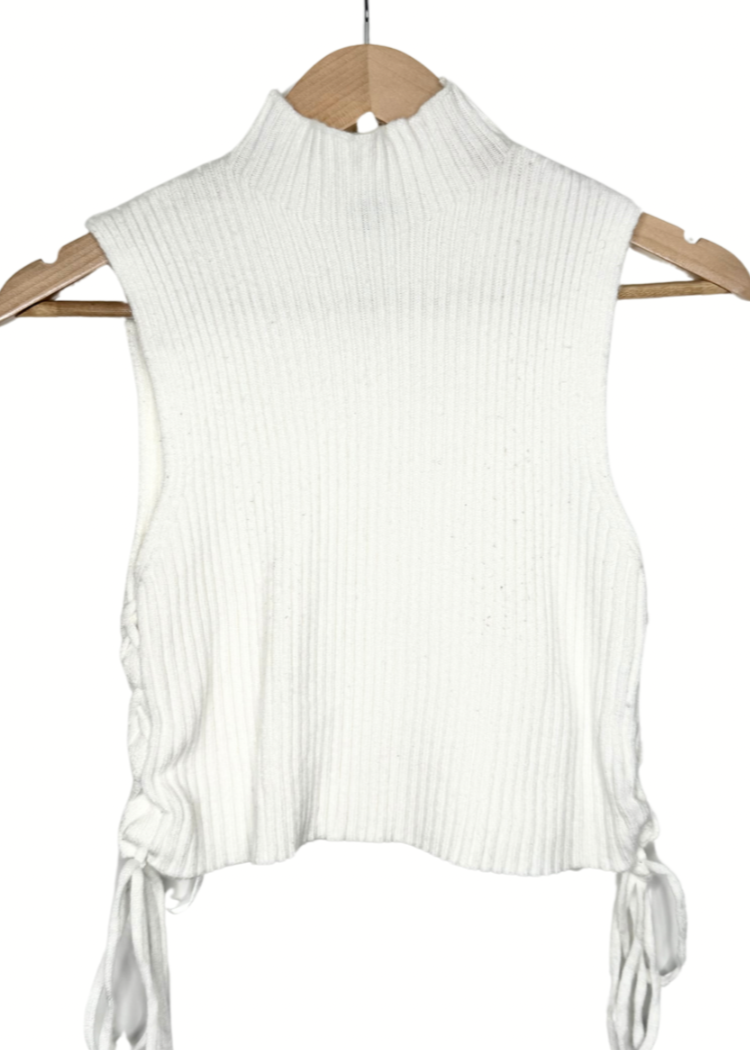 Warm and stylish cropped top with lace-up sides and a turtle neck. Perfect for pairing with skirts or jeans. Model is 5'2, 150 lbs, wearing a size Medium.